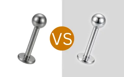 Dwa kolczyki do piercingu, jeden matowy, drugi błyszczący. Czy tytan to metal? Tak, jest.
